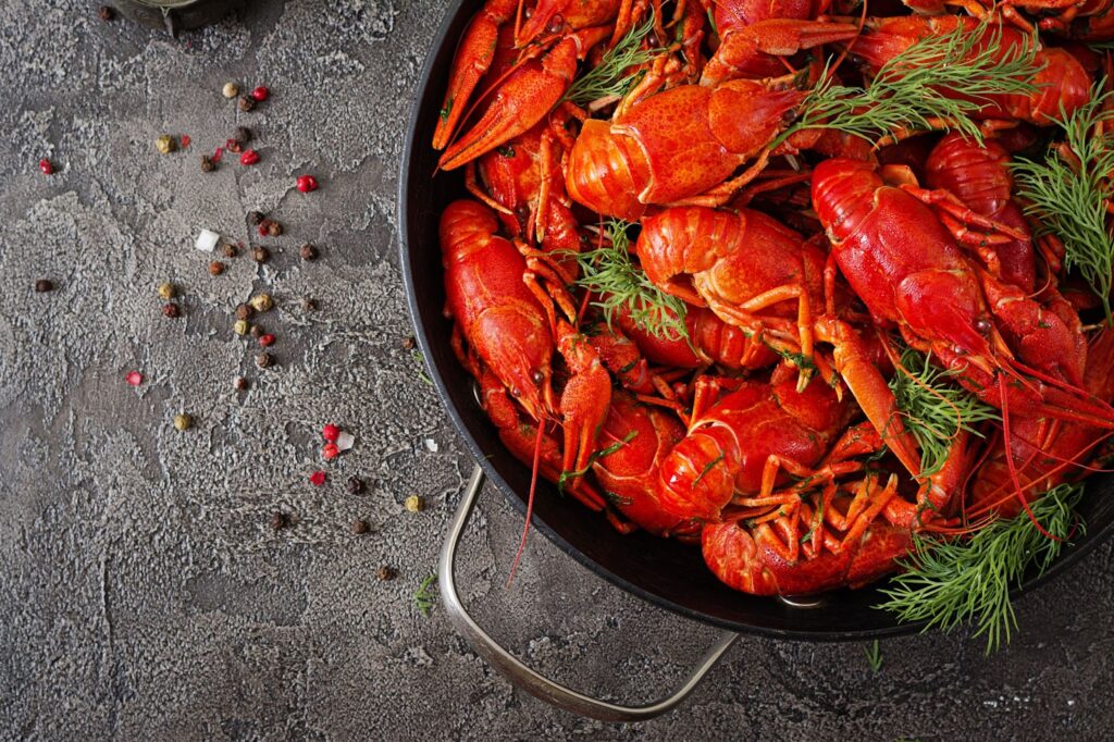 A pan of cooked Crayfish seasoned with aromatic herbs and spices.